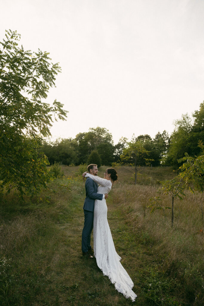 Bride and grooms outdoor sunset wedding portraits during their summer camp wedding in Wisconsin