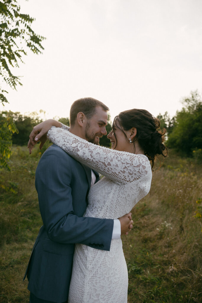 Bride and grooms outdoor sunset wedding portraits during their summer camp wedding in Wisconsin