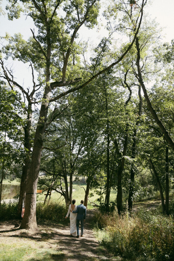 Bride and groom walking down a dirt path