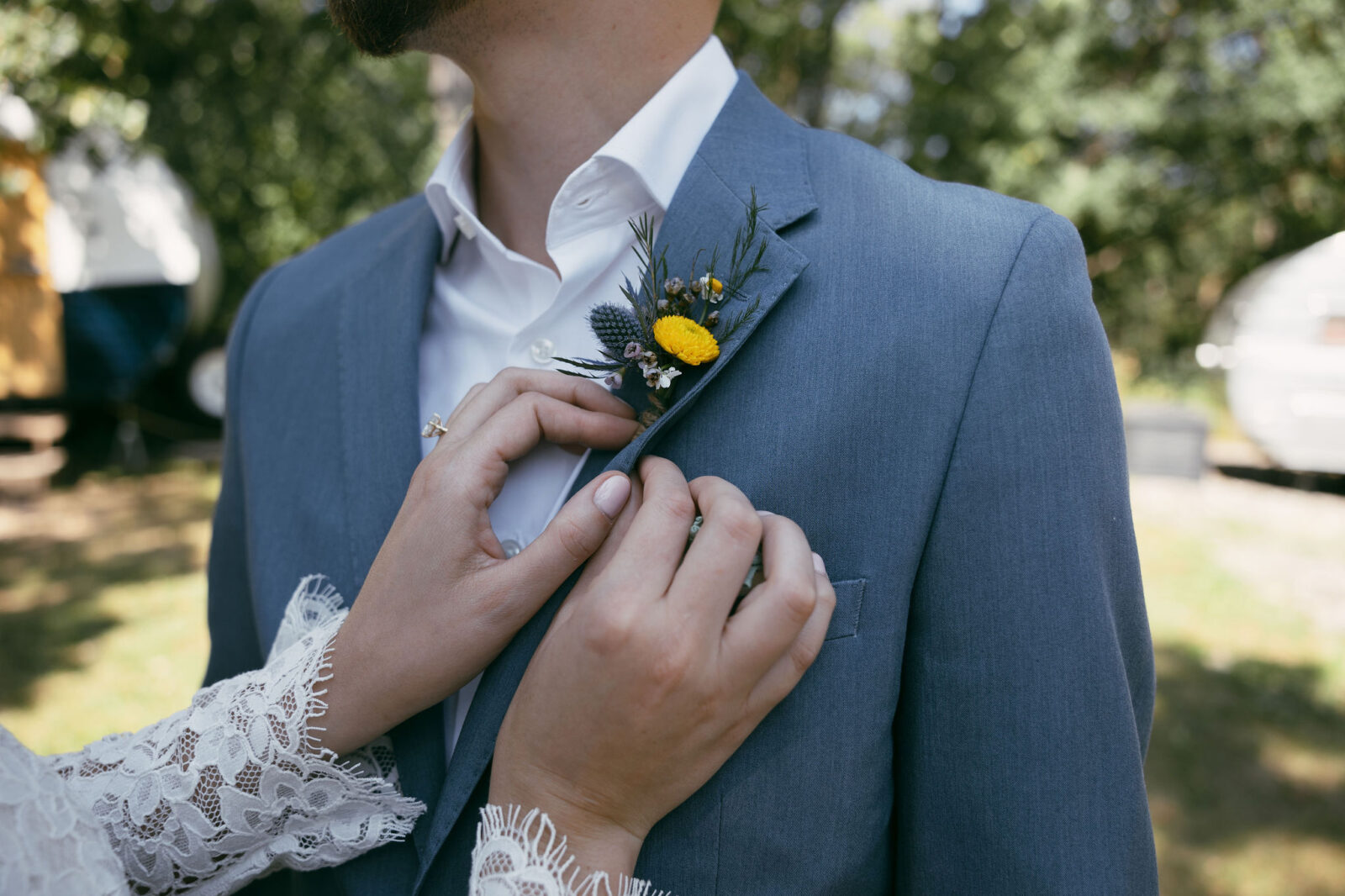 Bride fixing grooms boutonniere 