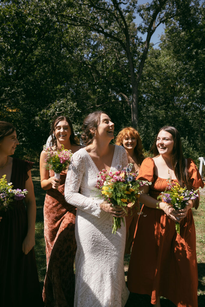 Candid bride and bridesmaids photo from a summer camp wedding in WIsconsin at Camp Kettlewood