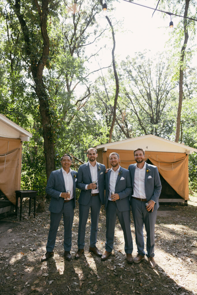 Groom and groomsmen portrait from a summer camp wedding in Wisconsin at Camp Kettlewood