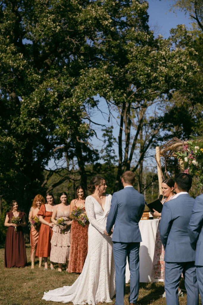 An outdoor summer camp wedding ceremony at Camp Kettlewood in Wisconsin