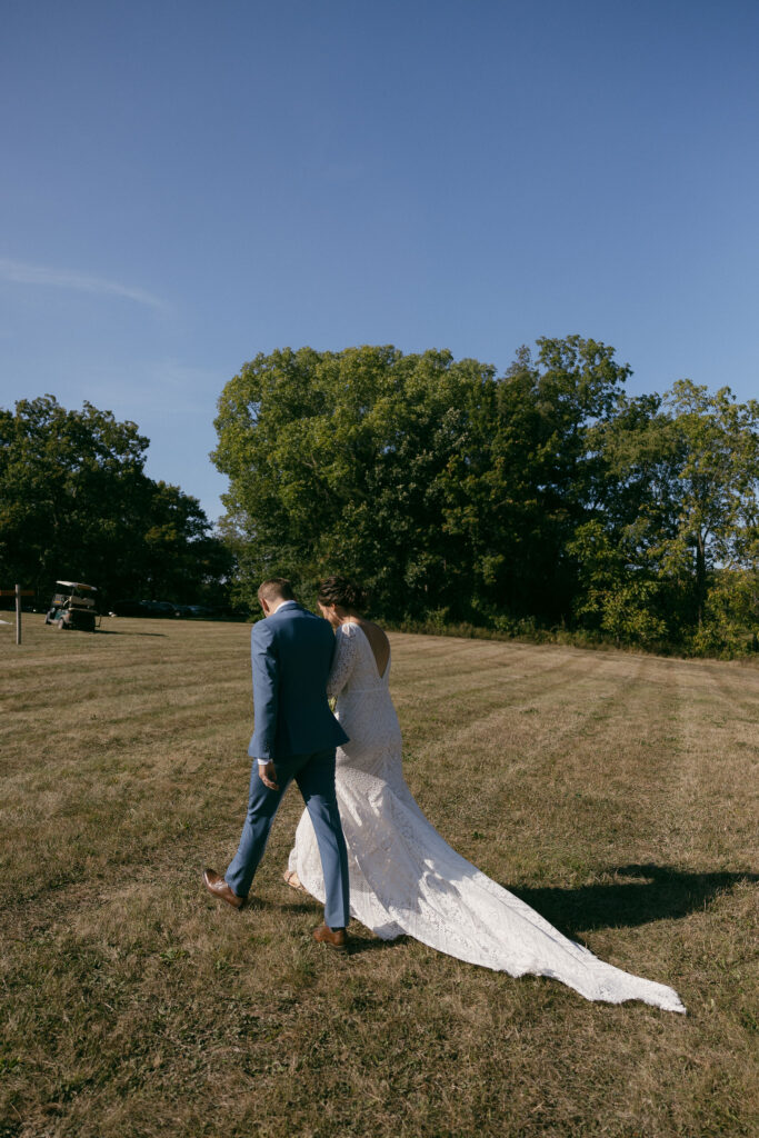 Bride and groom walking away after their summer camp wedding ceremony in Wisconsin