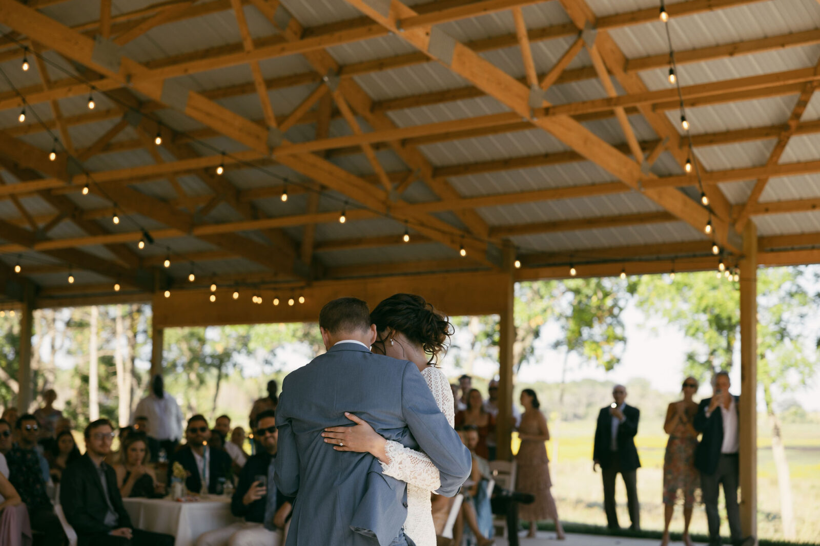 Bride and grooms first dance during their summer camp wedding reception