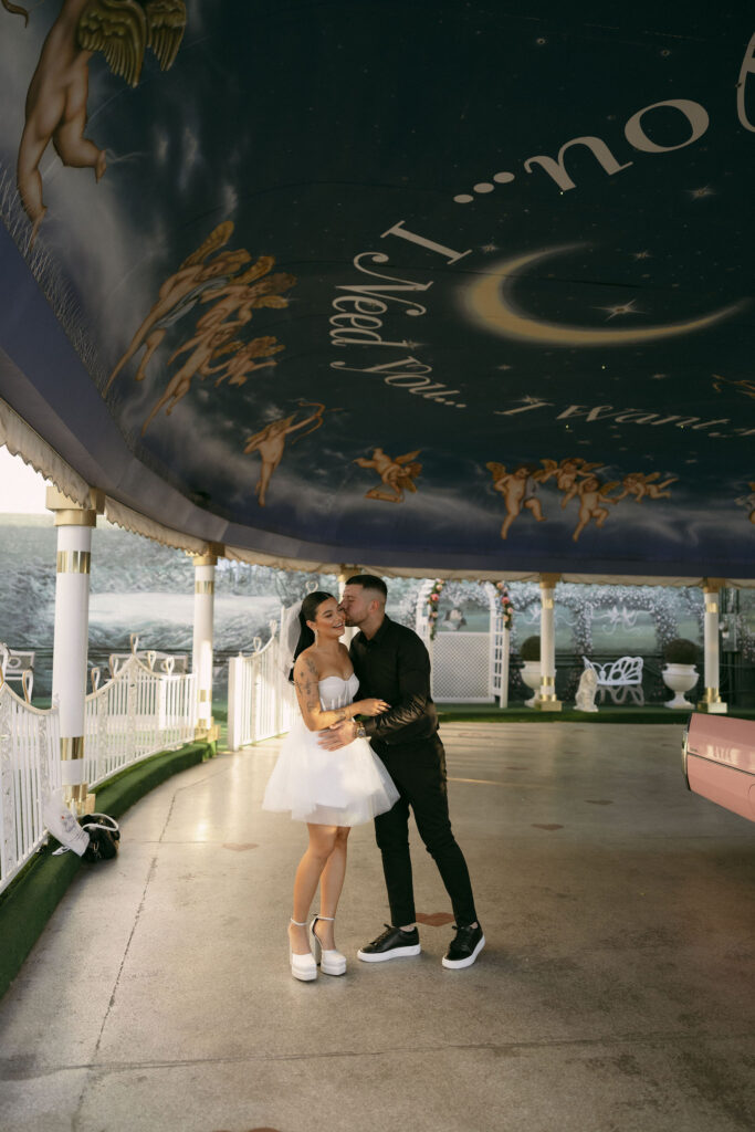 Groom kissing his bride in The Tunnel of Love during their Little White Chapel elopement