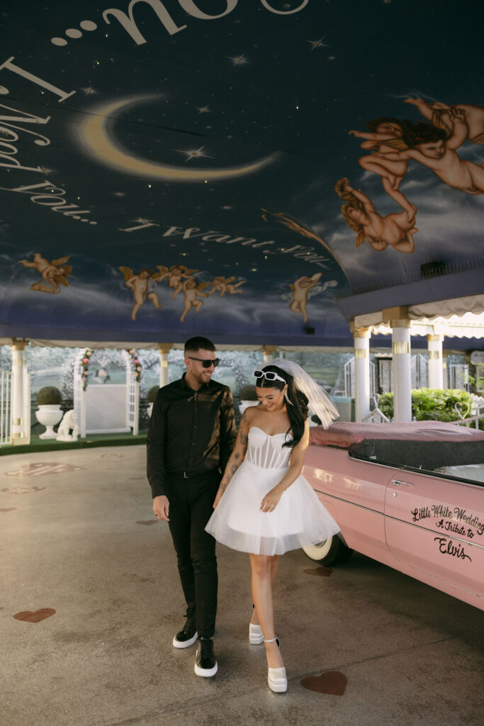 Bride and groom walking around in The Tunnel of Love at The Little White Wedding Chapel