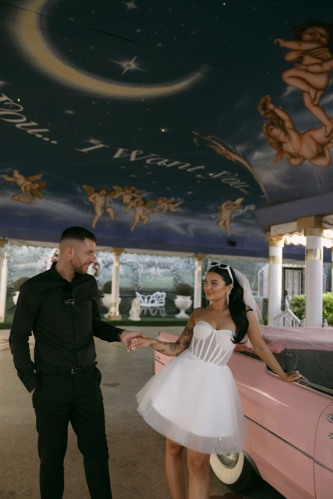 Bride and grooms editorial elopement portraits with the Pink Cadillac at Little White Wedding Chapel in Las Vegas