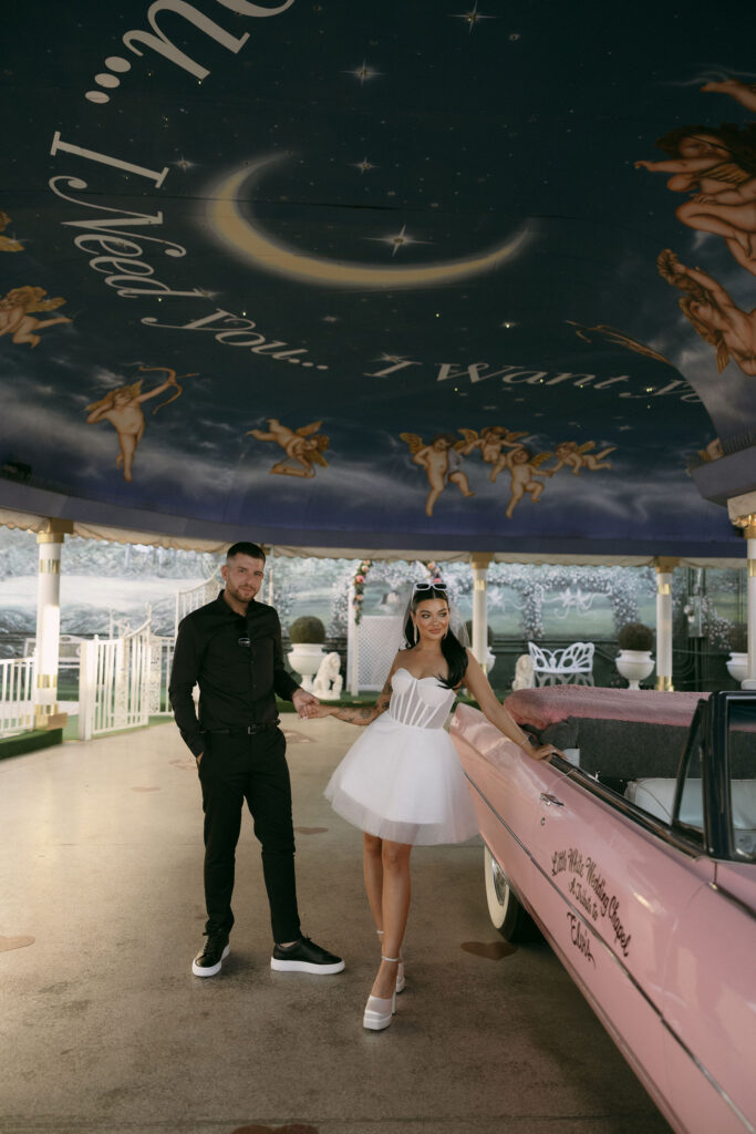 Bride and grooms editorial elopement portraits with the Pink Cadillac at Little White Wedding Chapel in Las Vegas