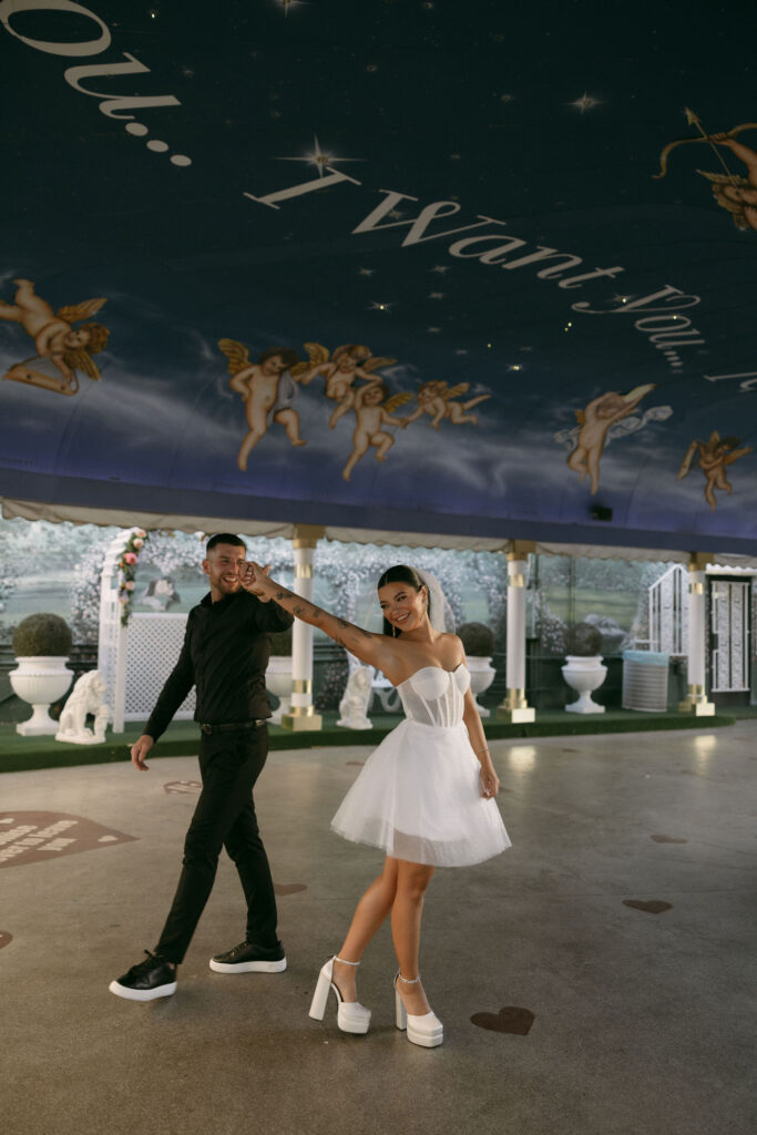 Bride and groom dancing in The Tunnel of Love at The Little White Wedding Chapel