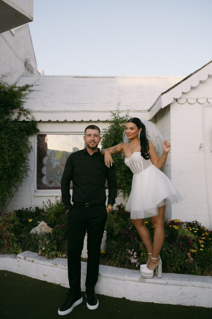 Editorial elopement photos of a bride and groom posing for portraits at The Little White Wedding Chapel in Las Vegas