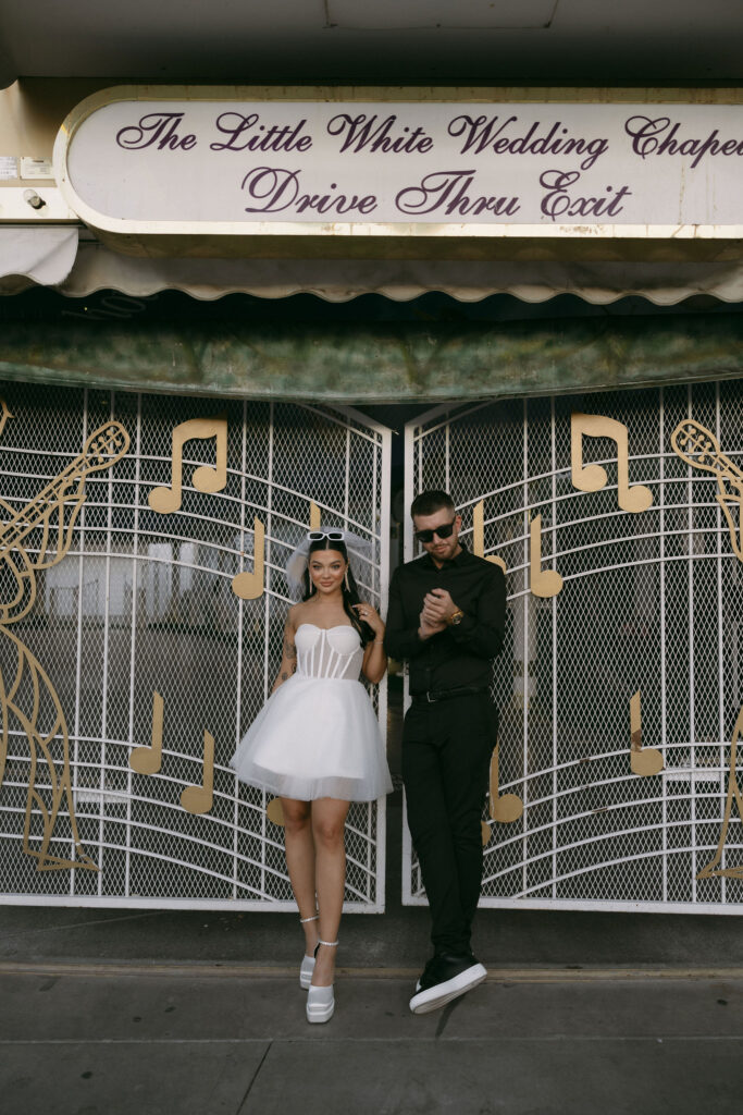 Bride and groom posing for portraits in front of the Drive Thru Tunnel of Love exit