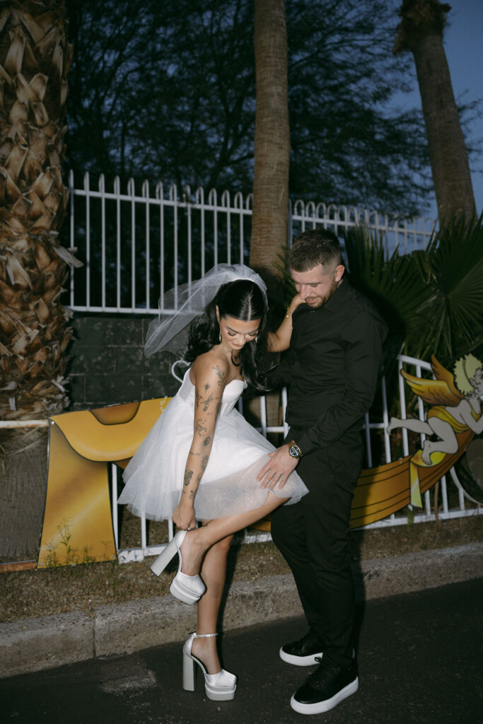 Flash photo of a bride fixing her heel