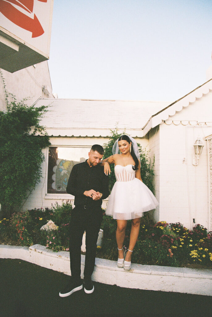 Editorial elopement photo of a bride and groom posing at The Little White Chapel