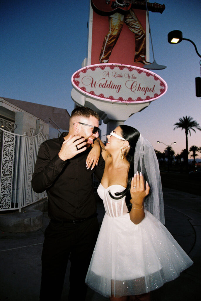 Flash film elopement photo of a bride and groom at The Little White Wedding Chapel