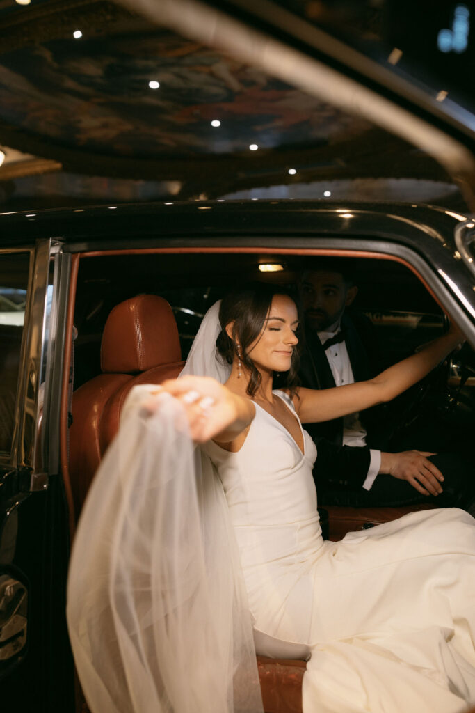 Bride and grooms flash wedding portraits in a Rolls-Royce for their Las Vegas wedding