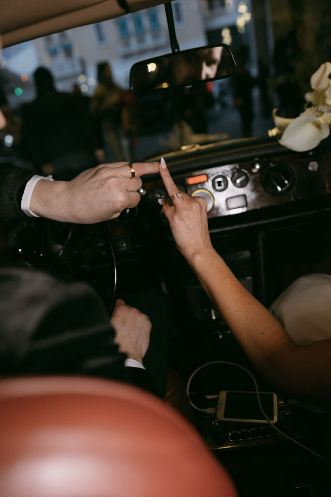 Bride and groom showing off their wedding rings