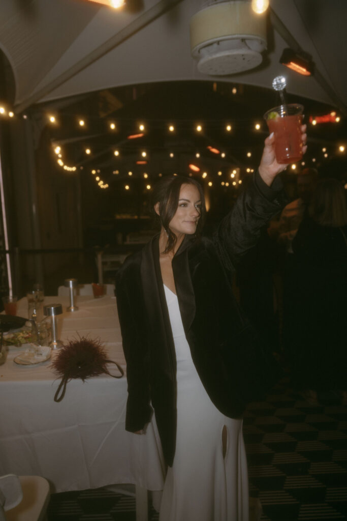 Bride holding up her reception drink