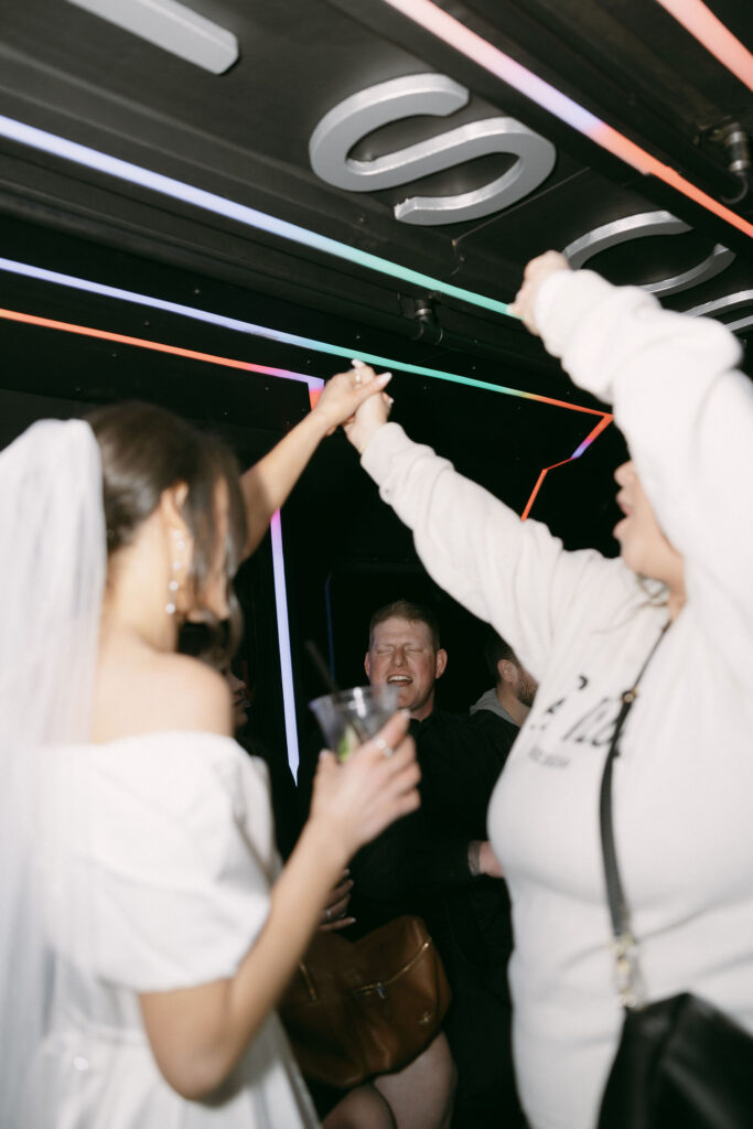 Bride and guests dancing on the party bus