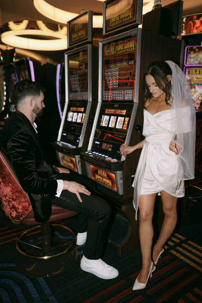 Bride and groom posing for portraits in the casino in Las Vegas