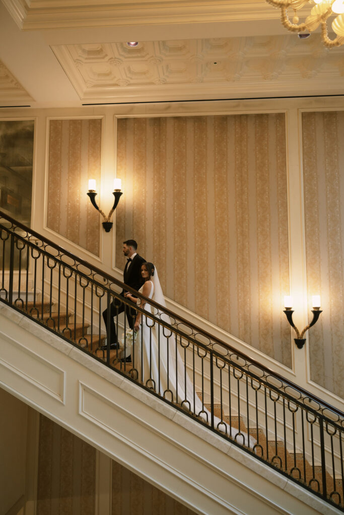 Bride and groom walking up a staircase