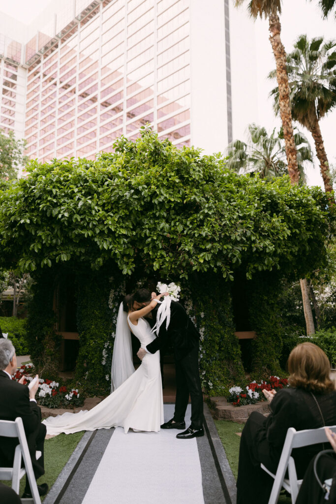 Bride and groom kissing during their Flamingo Gazebo wedding ceremony in Las Vegas