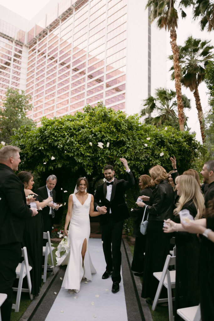 Bride and groom walking back down the aisle as husband and wife after their Flamingo Gazebo wedding ceremony in Las Vegas