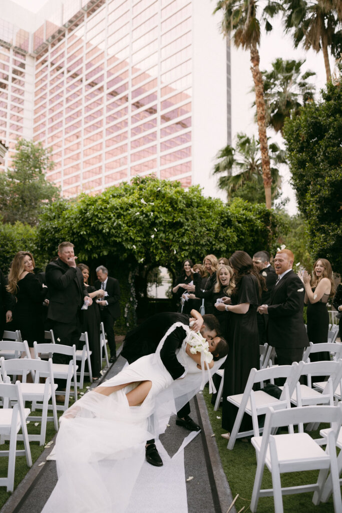 Bride and grooms dip kiss after their Flamingo Gazebo wedding ceremony in Las Vegas