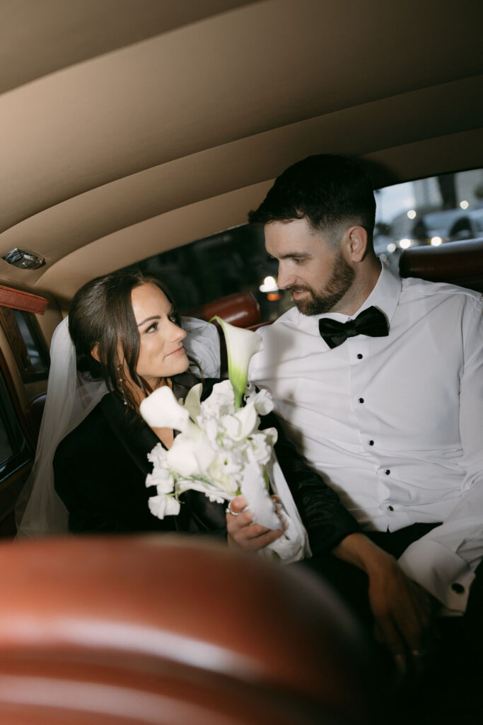 Bride and grooms flash wedding portraits in a Rolls-Royce for their Las Vegas wedding