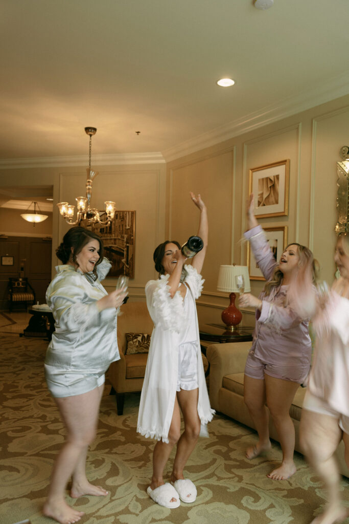 Bride and her bridesmaids with champagne 