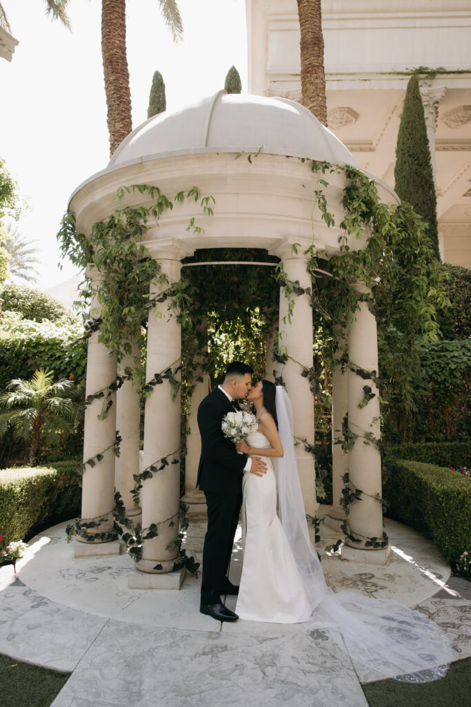 Bride and groom kissing during their Caesars Palace wedding ceremony in Las Vegas