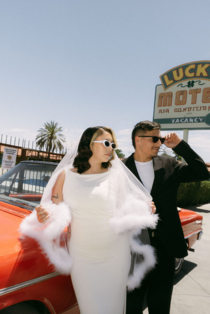 Bride and grooms Las Vegas elopement photos with a classic red car