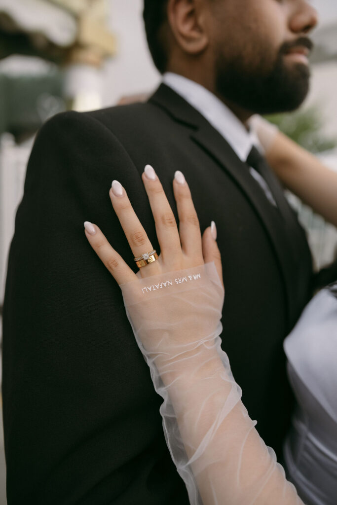 Close up shot of a bride wearing sheer sleeves with custom lettering 