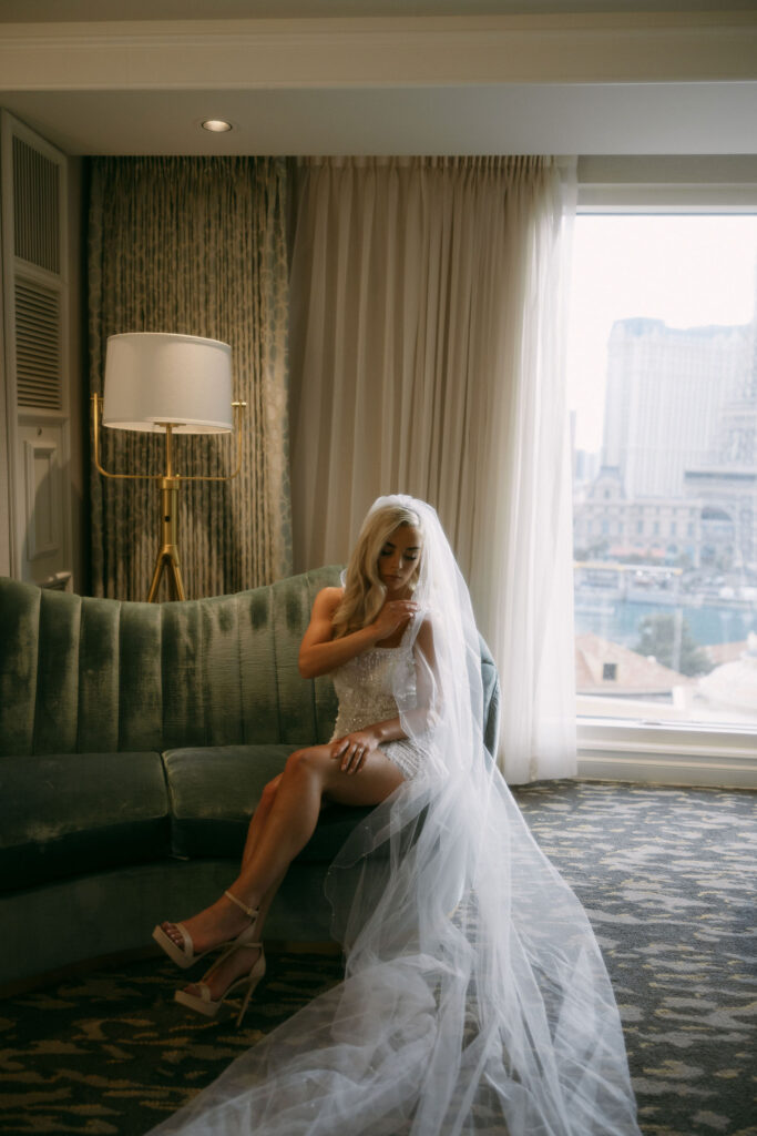 Bride sitting on a couch at Bellagio for her Las Vegas elopement 