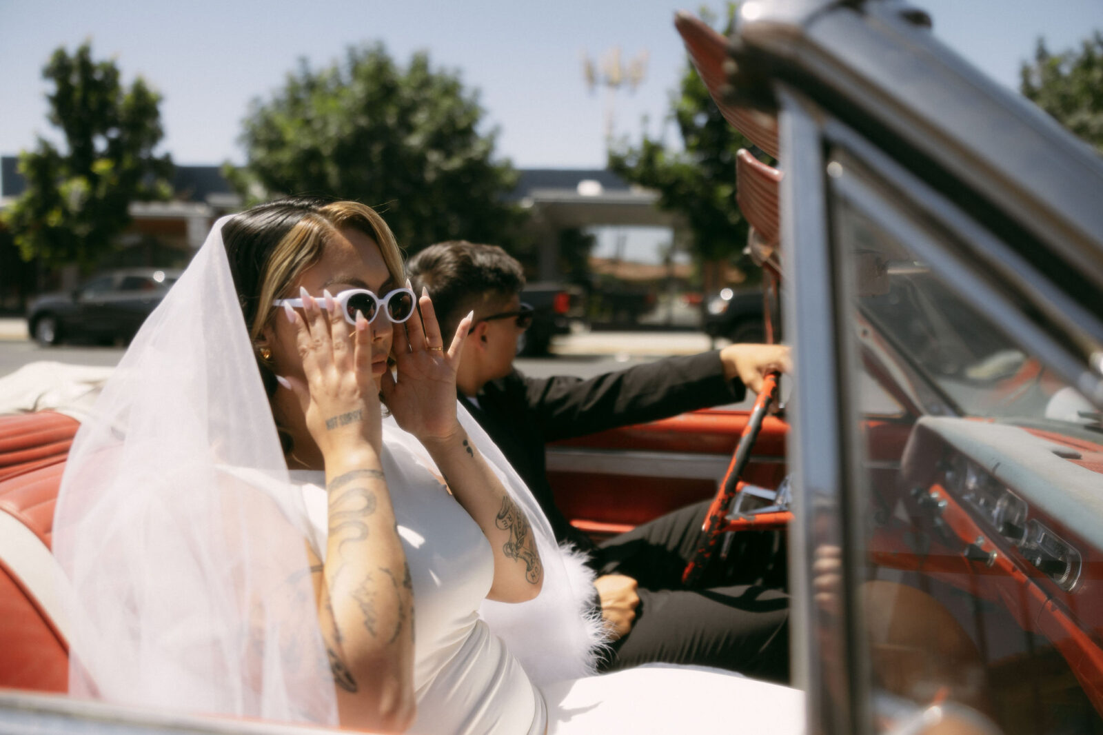 Bride and grooms Las Vegas elopement photos in a classic red car