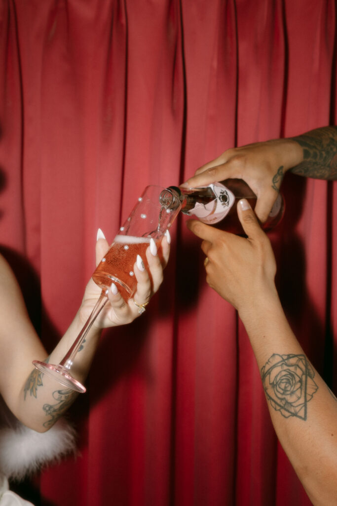 Bride and groom pouring champagne into glasses