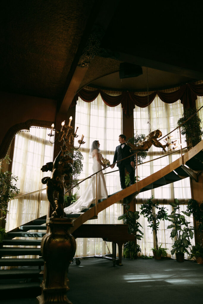 Bride and grooms portraits on the staircase at Madonna Inn wedding venue in California