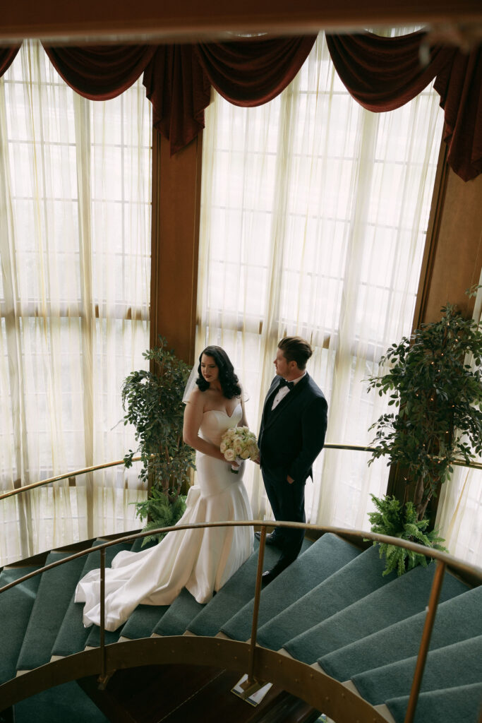 Bride and grooms portraits on the staircase at Madonna Inn wedding venue in California