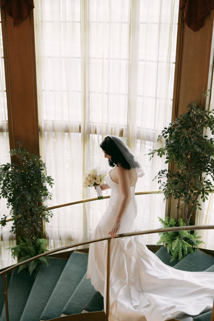 Indoor bridal portraits on the staircase at Madonna Inn wedding venue in California