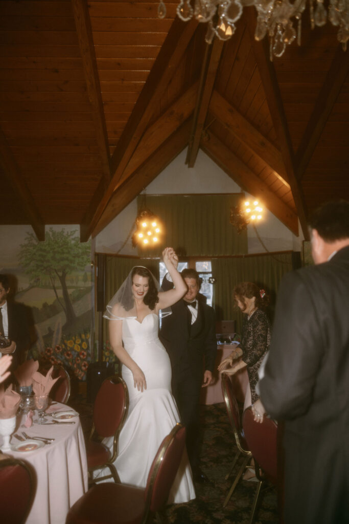 Bride and groom entering their reception