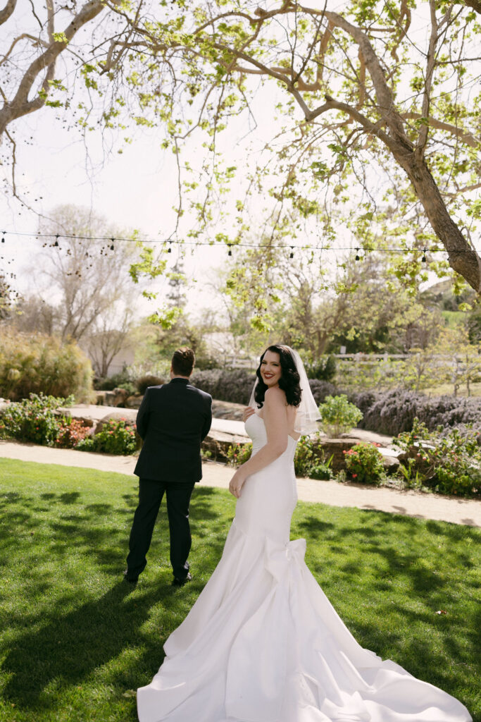 Bride and groom about to share their first look in the Secret Garden at Madonna Inn wedding venue