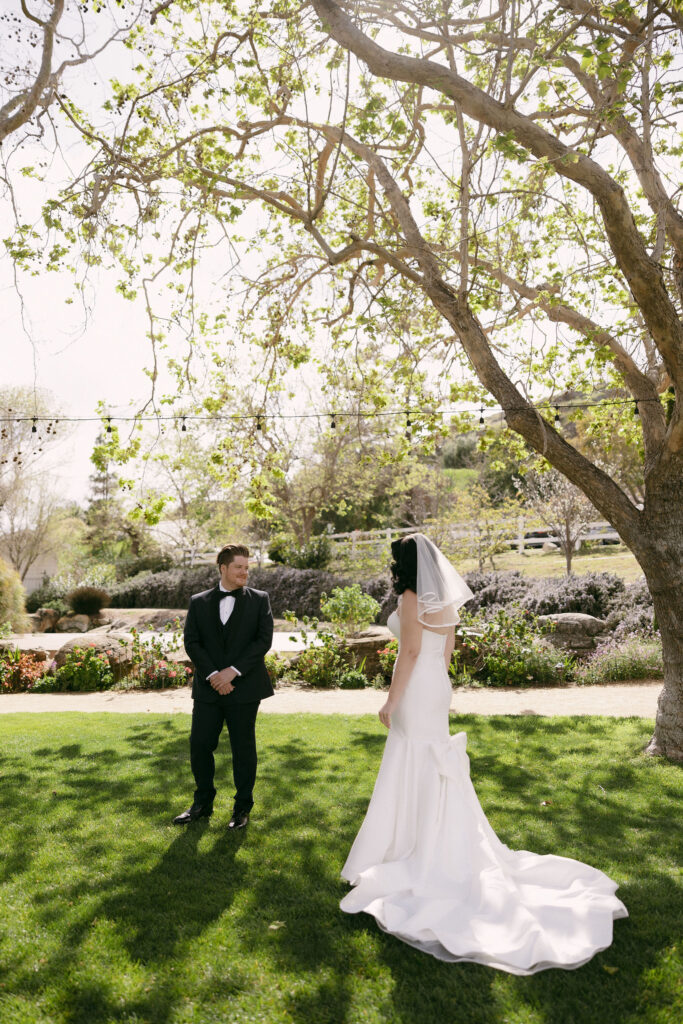 Bride and groom sharing their first look in the Secret Garden at Madonna Inn wedding venue