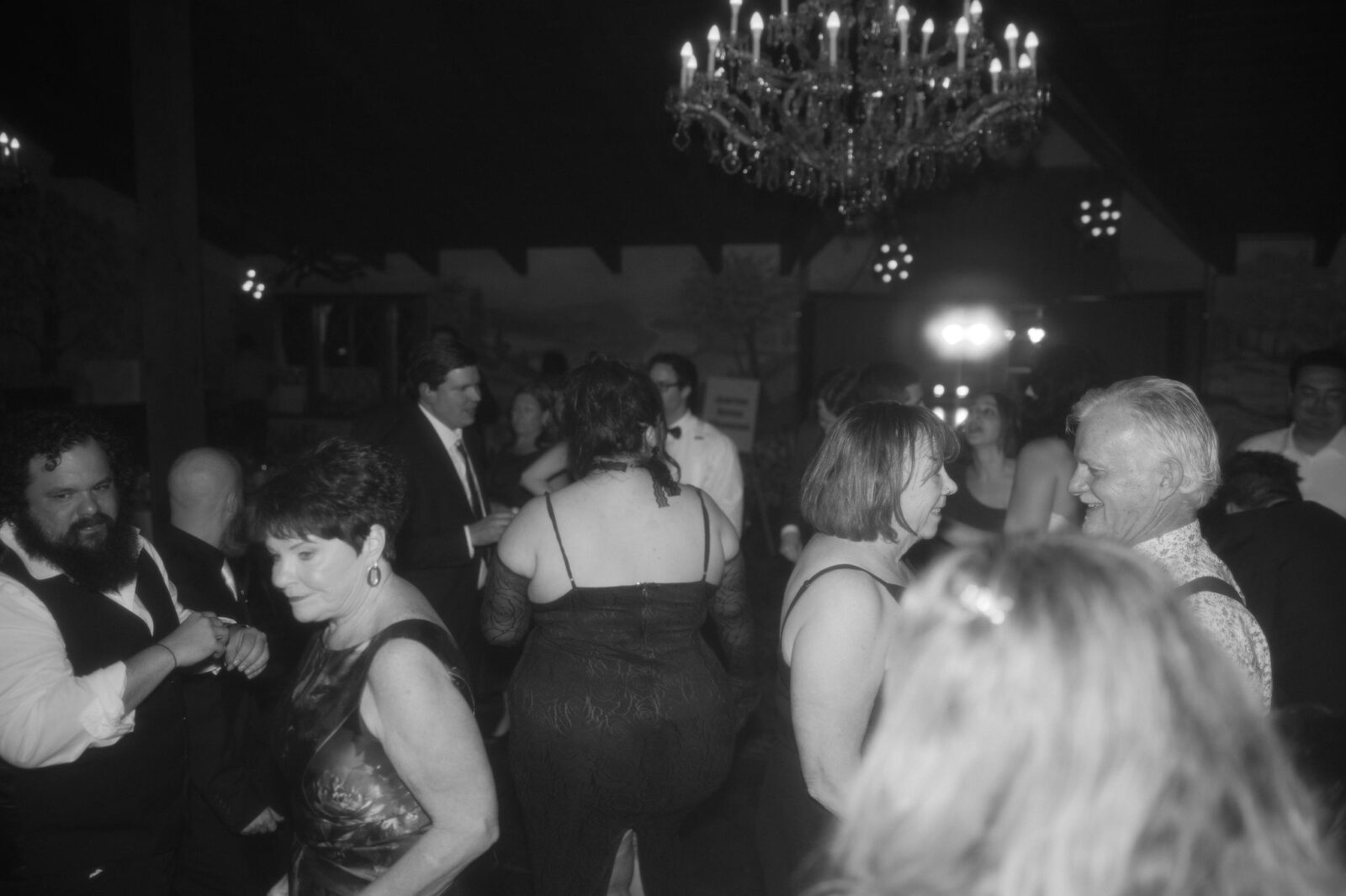 Black and white photo of guest dancing during a wedding reception
