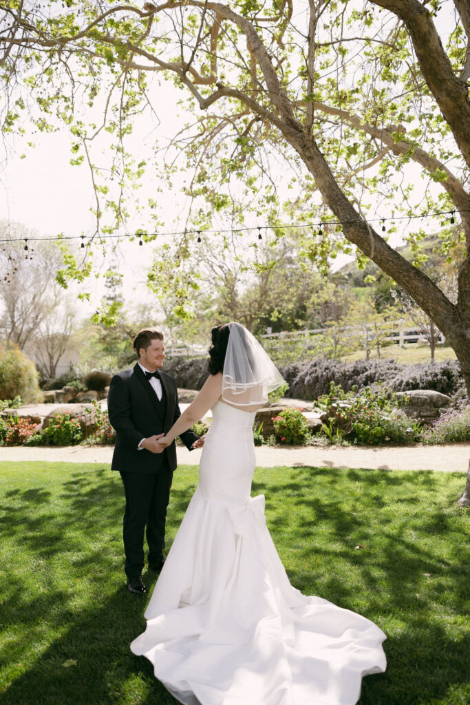 Bride and groom sharing their first look in the Secret Garden at Madonna Inn wedding venue