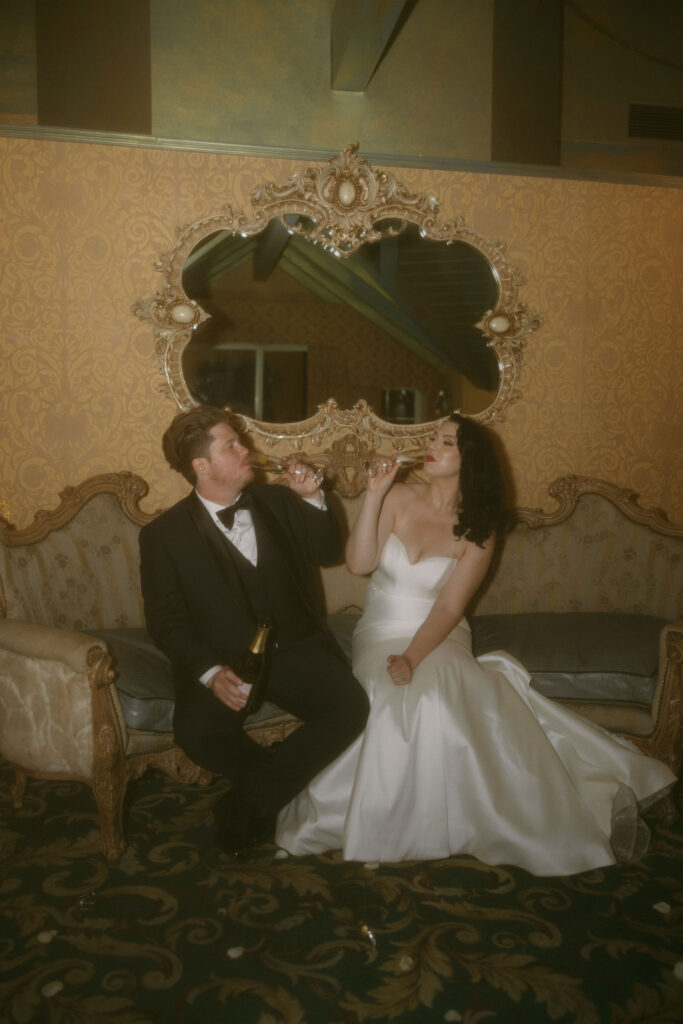 Bride and groom drinking champagne together