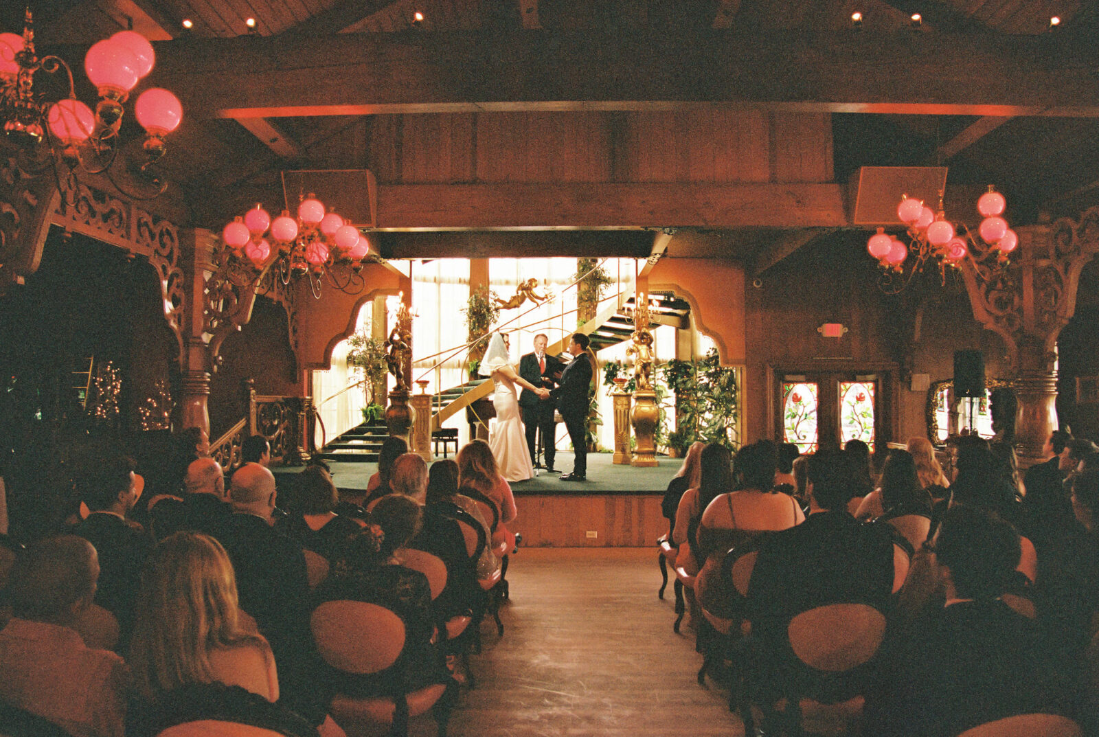 An indoor Madonna Inn wedding ceremony captured on film