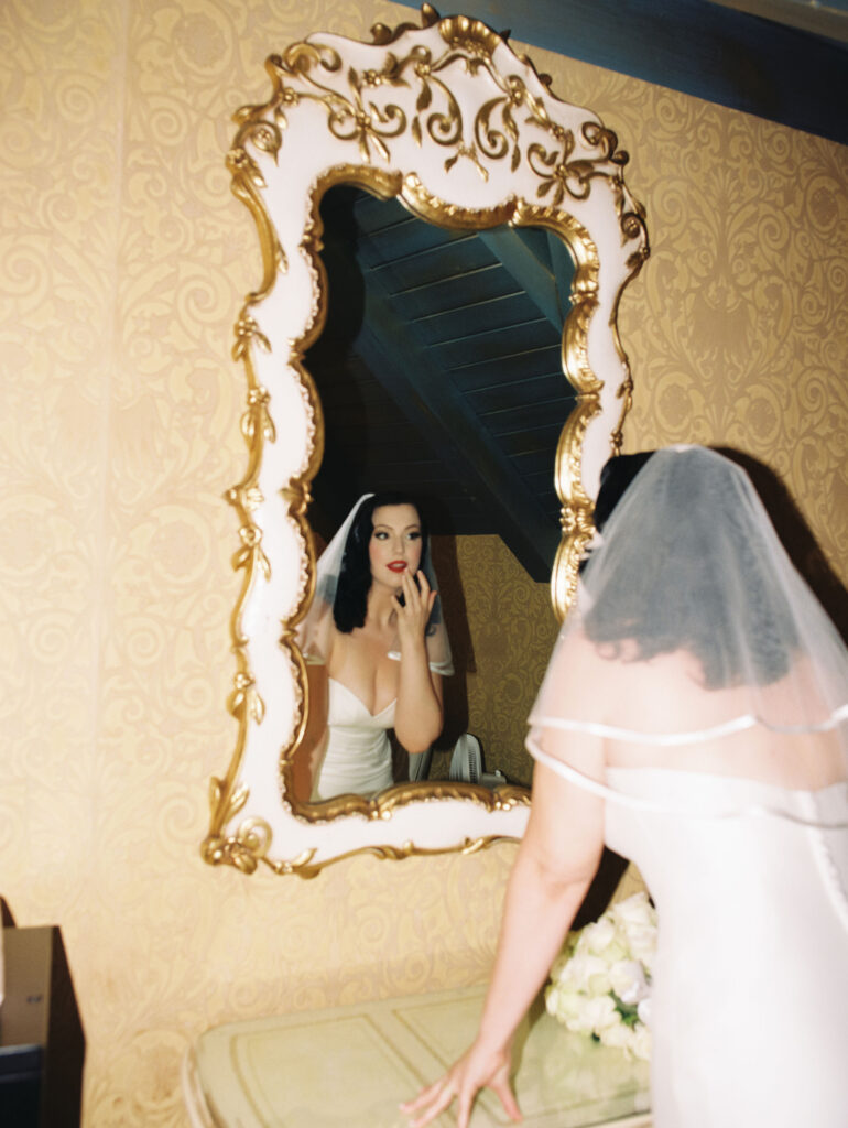 Bride looking at herself in the mirror captured on film