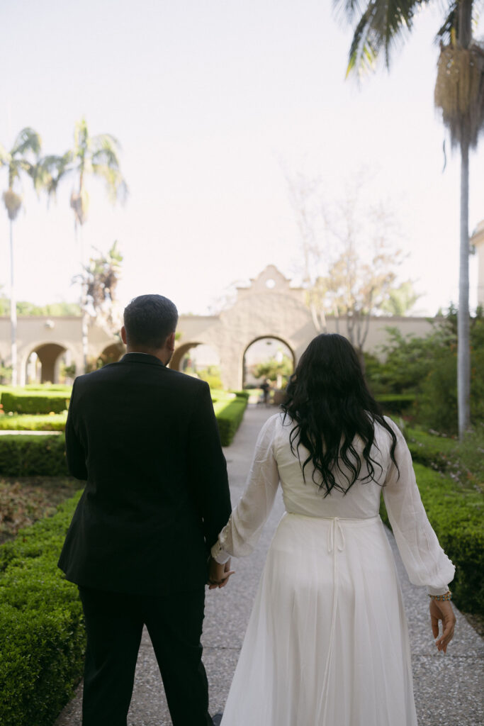 Couple walking through Alcázar Garden 