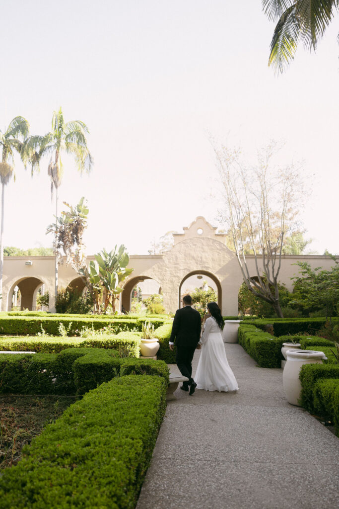 Couple walking through Alcázar Garden 