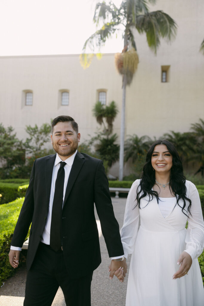 Couples holding hands and walking through the gardens of Balboa Park